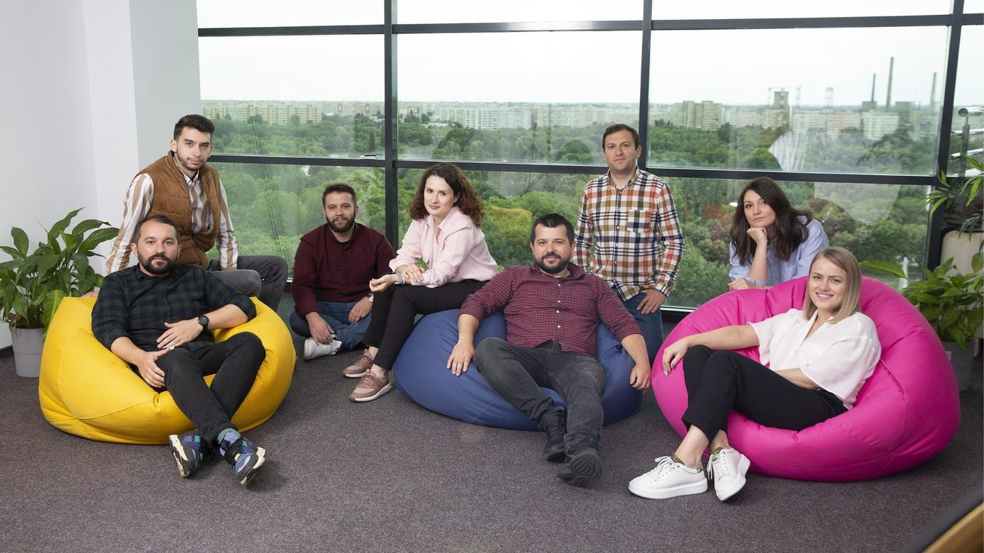 The team on beanbags by the studio window