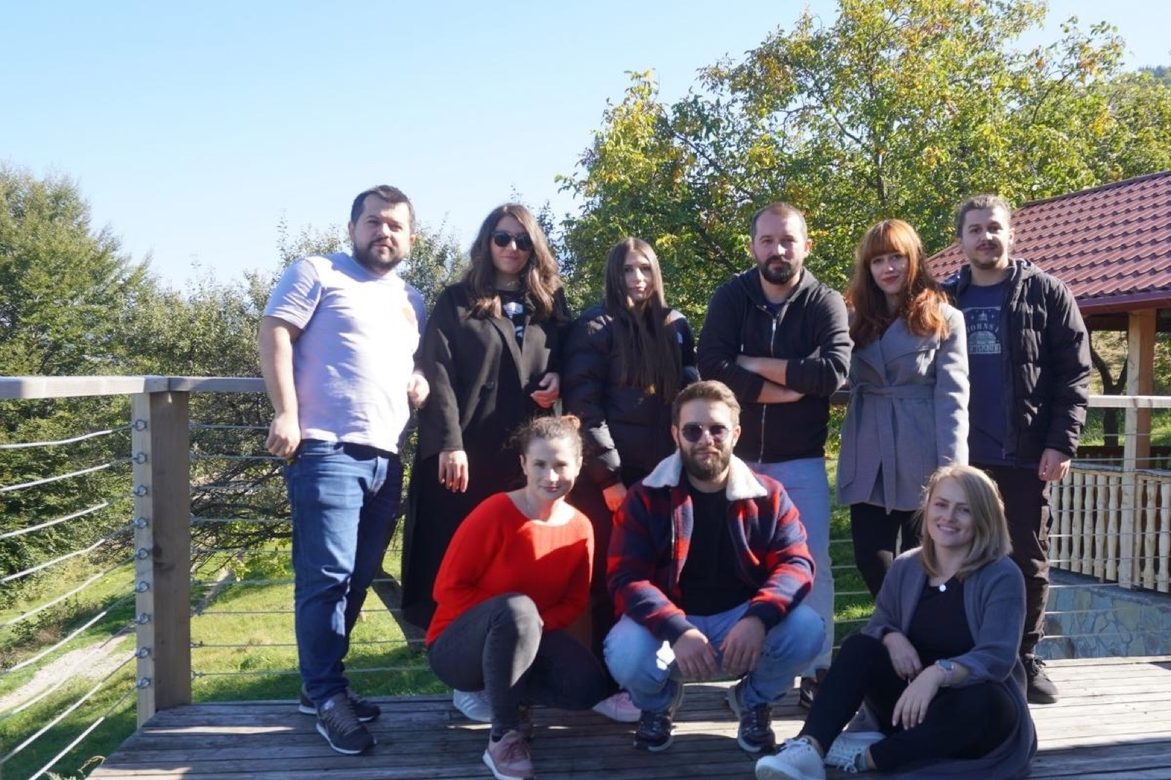 The team on a mountain deck on a team day